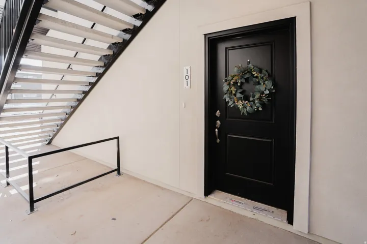 Doorway to property featuring stucco siding