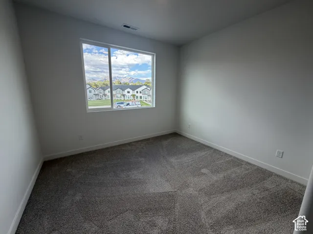 Neutral-toned walls complement the gray carpeting