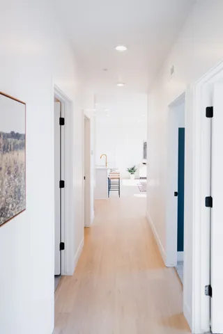 Hall with light wood-style floors and recessed lighting