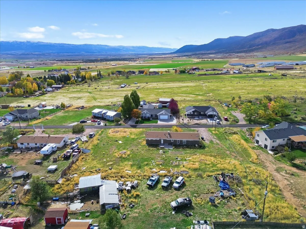 Aerial view of property's location featuring a mountainous background