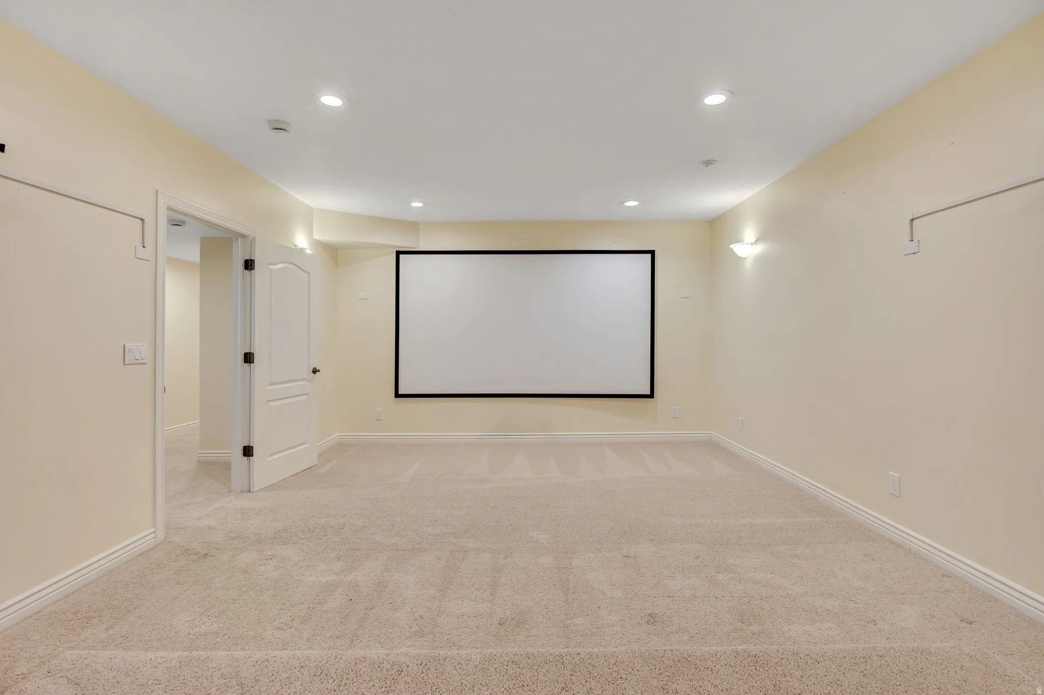 Home theater room featuring light colored carpet and recessed lighting