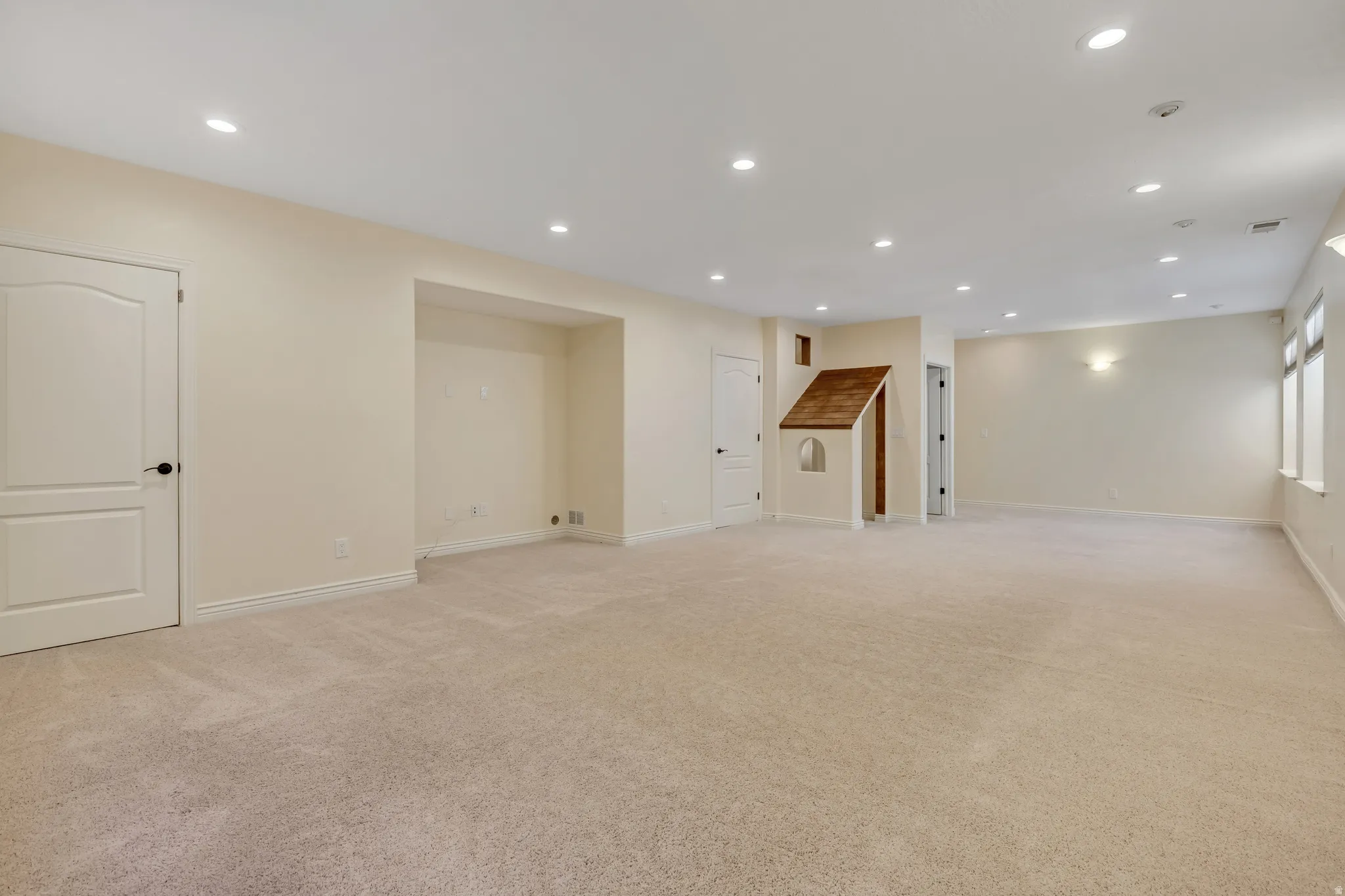 Basement with recessed lighting and light carpet