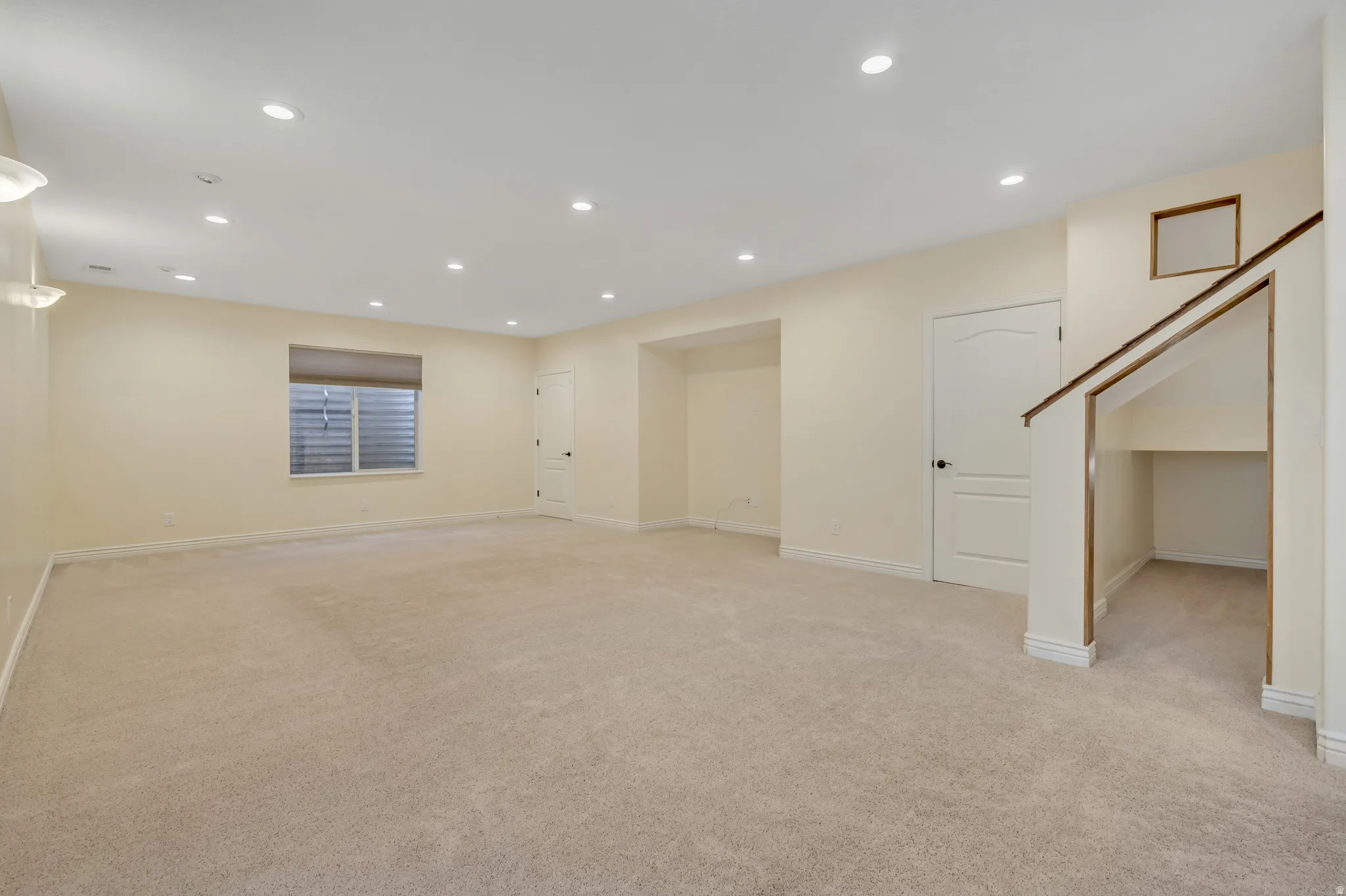 Basement with light colored carpet and recessed lighting