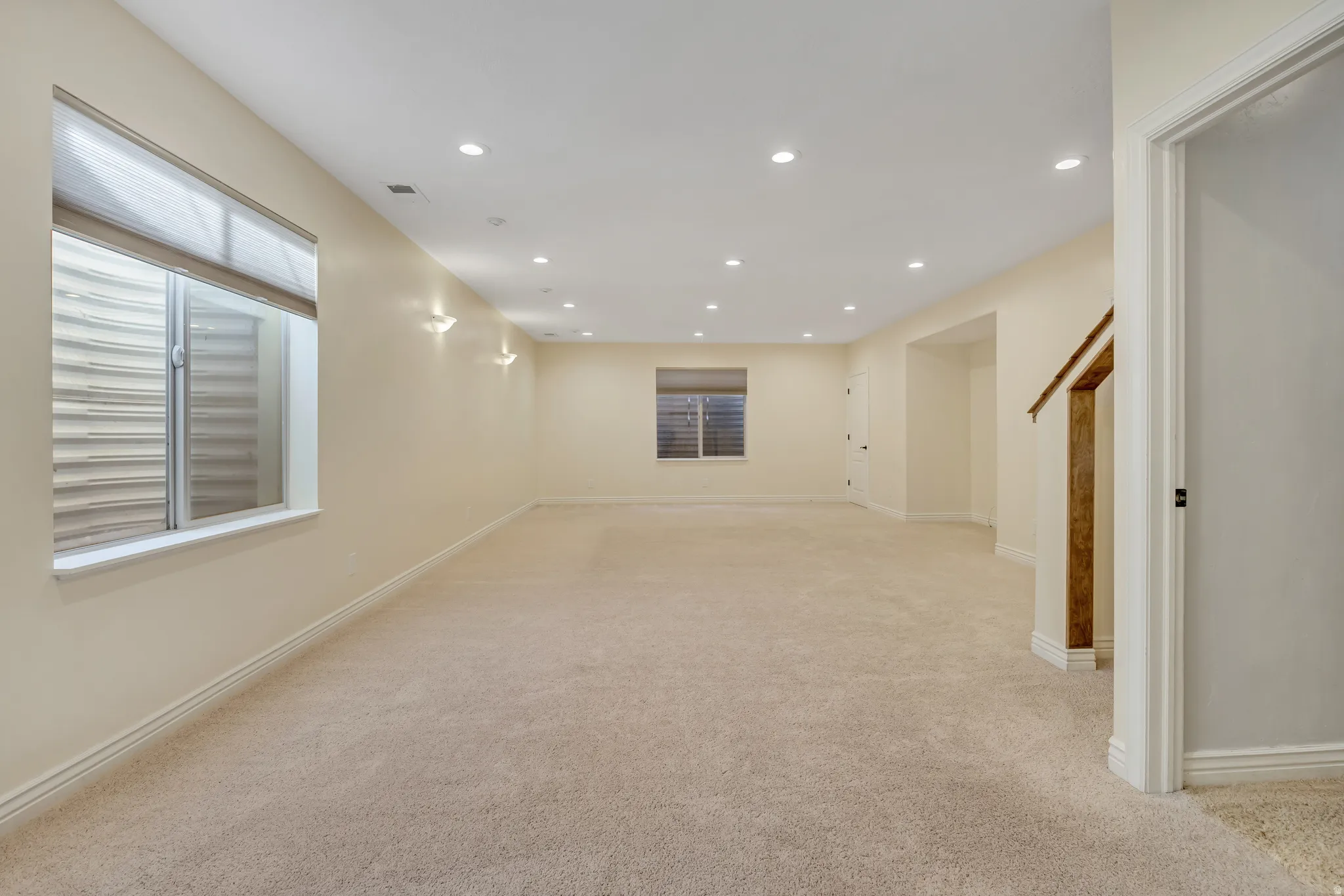 Basement featuring recessed lighting and light carpet