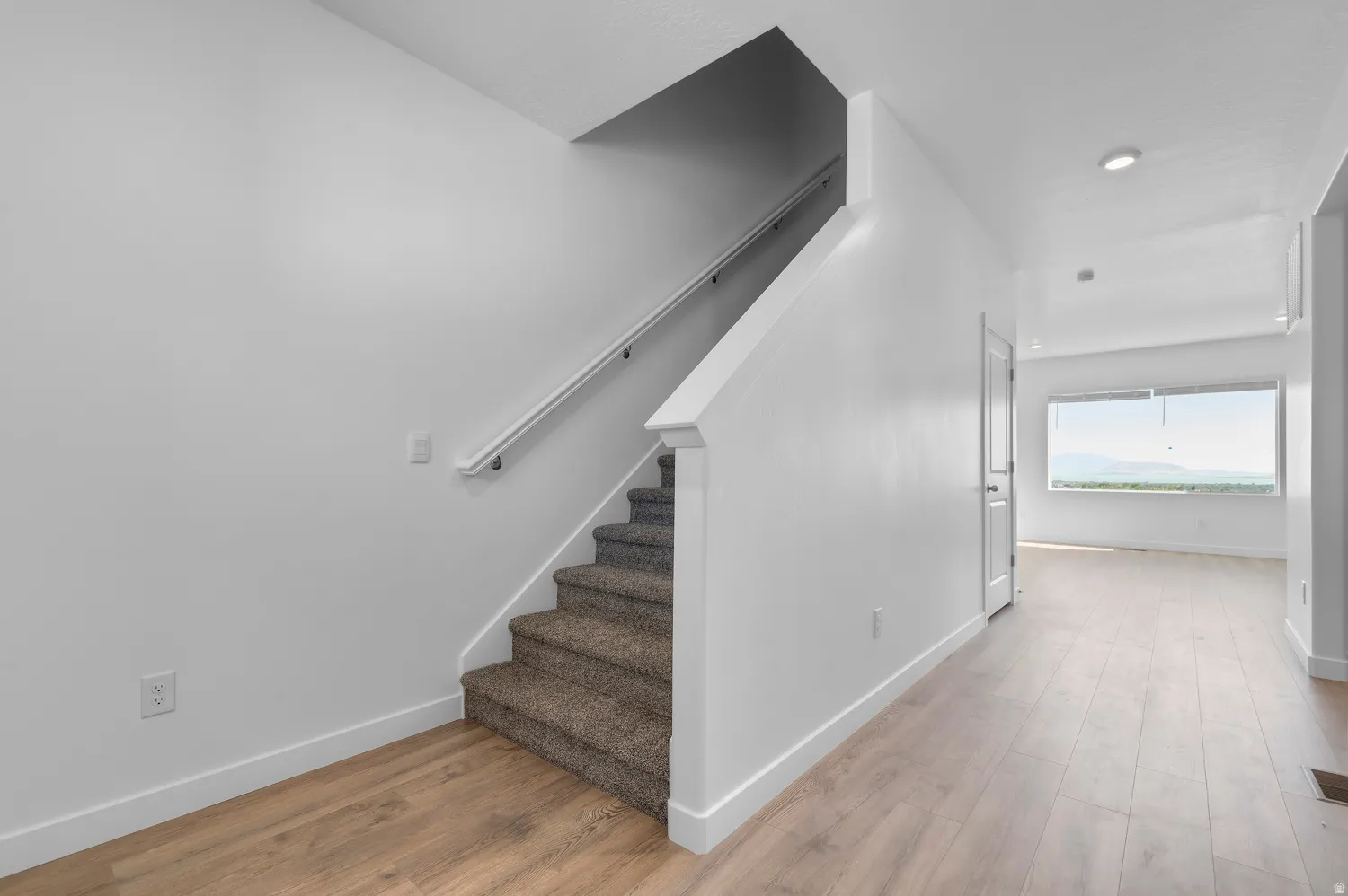 Stairway featuring baseboards and wood finished floors