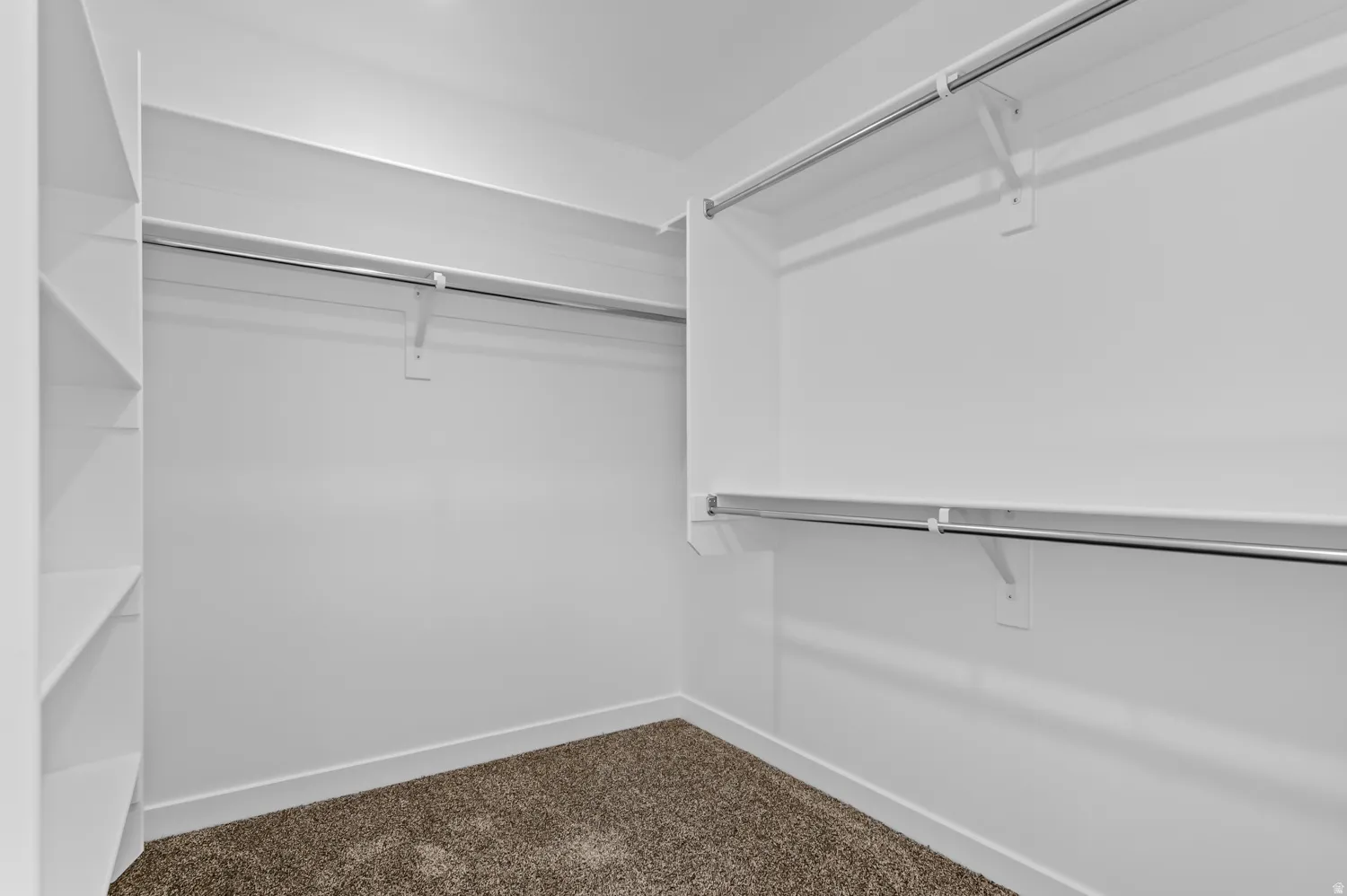 Walk in closet with dark carpet
