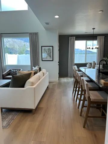 Open-concept living area featuring wood-finish flooring throughout