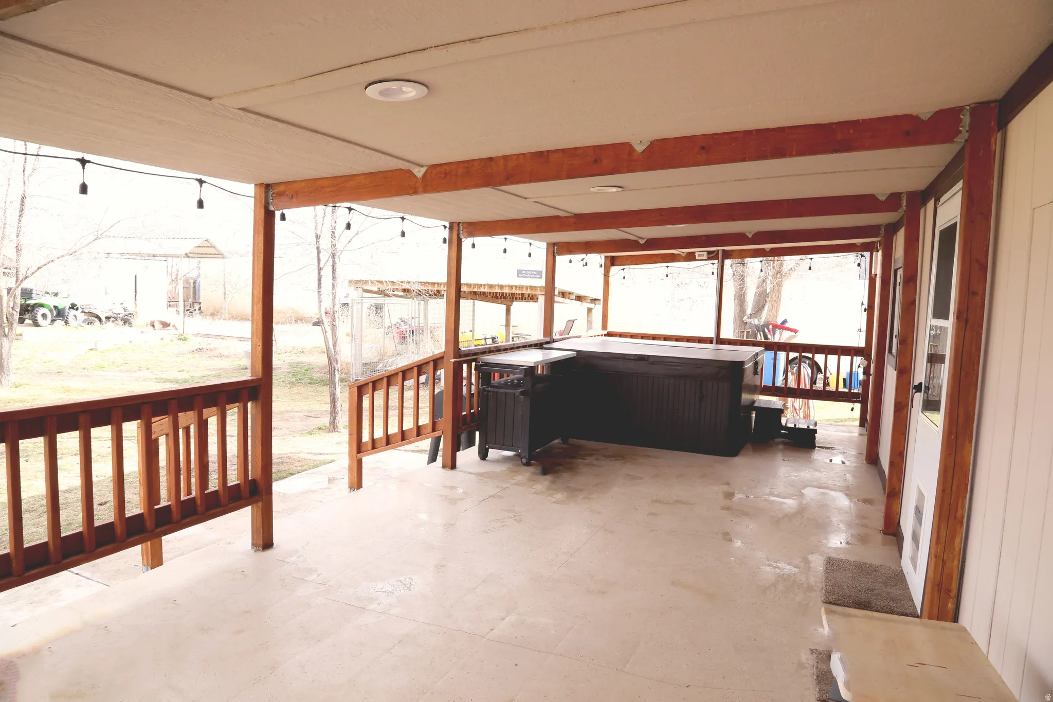 Sunroom / solarium with a jacuzzi and a patio area
