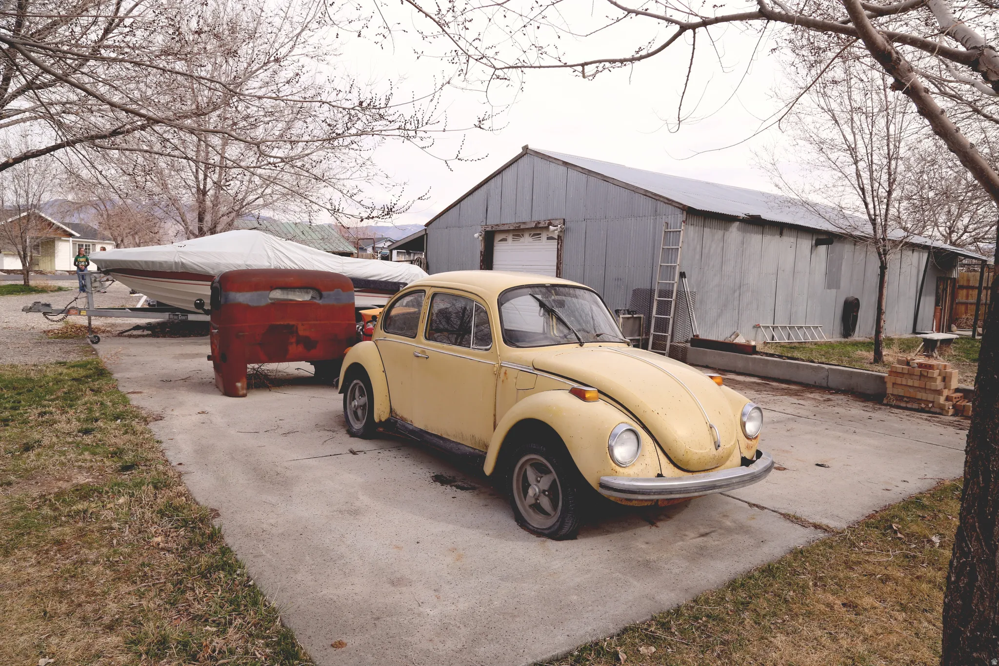 View of outdoor structure with driveway