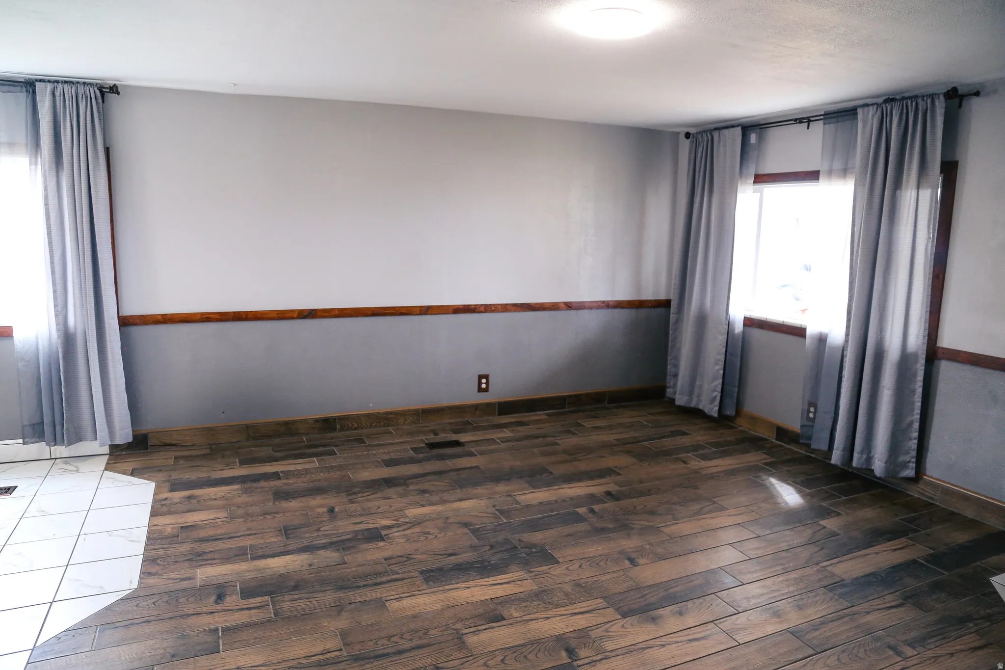 Empty room featuring dark wood finished floors