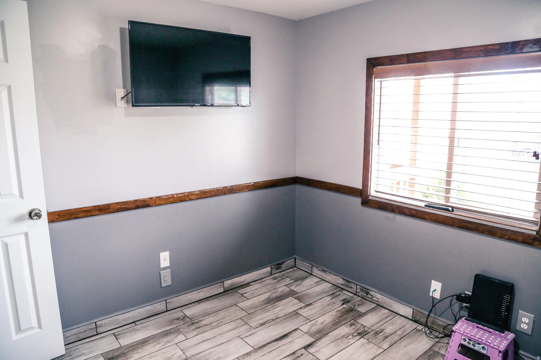 Empty room with wood tiled floors and baseboards