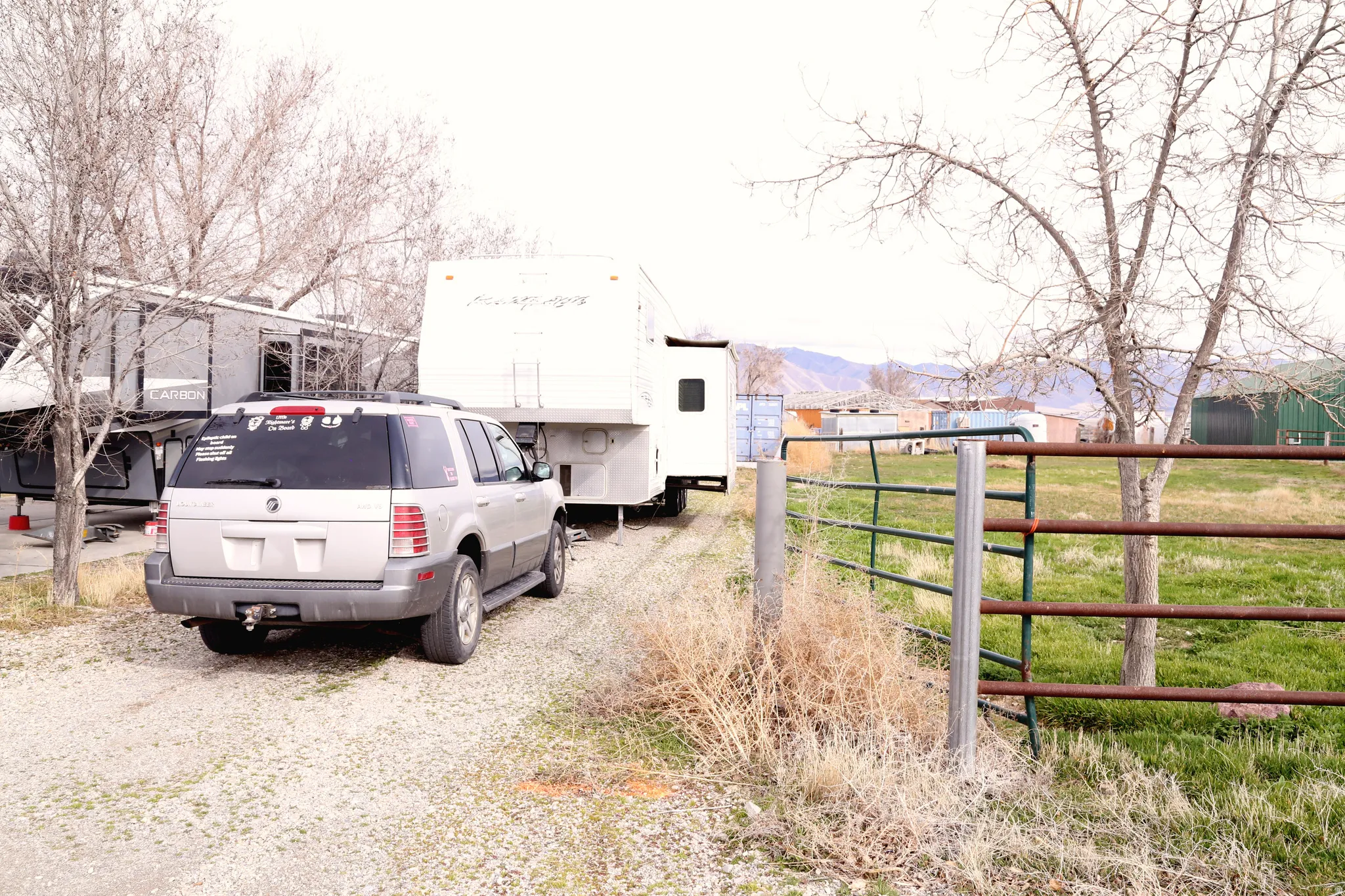 View of dirt / gravel driveway with a gated entry and a mountain view