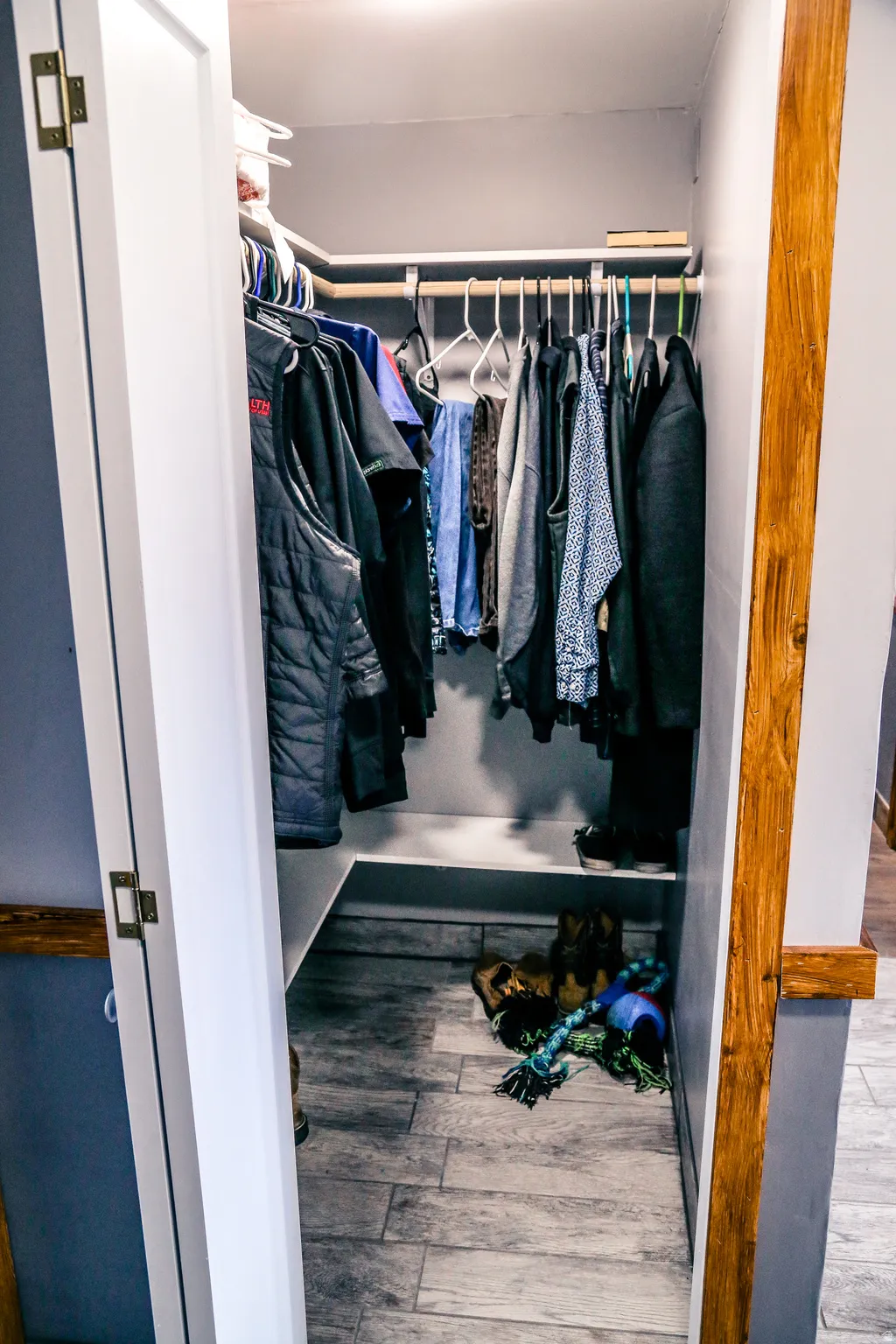 Walk in closet with light wood-style floors