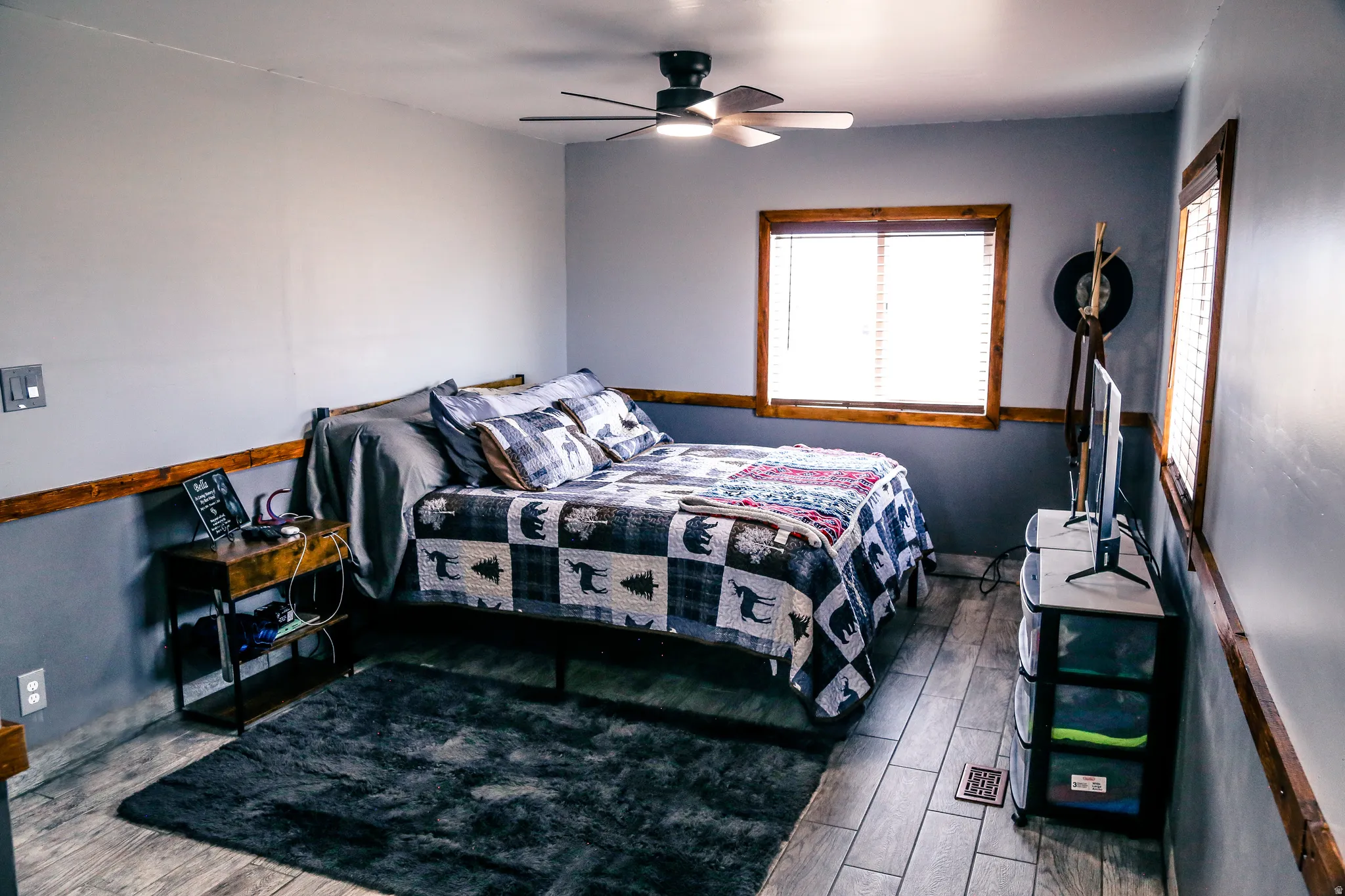 Bedroom with dark wood-type flooring and a ceiling fan