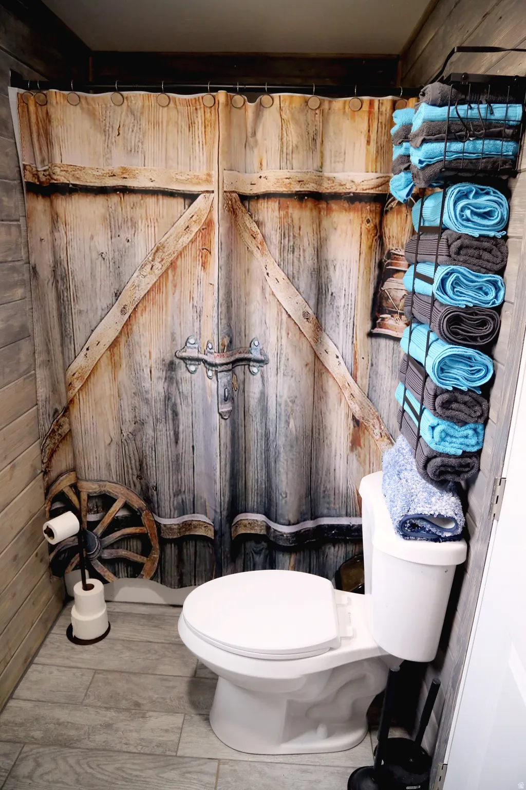 Bathroom featuring toilet and wood walls