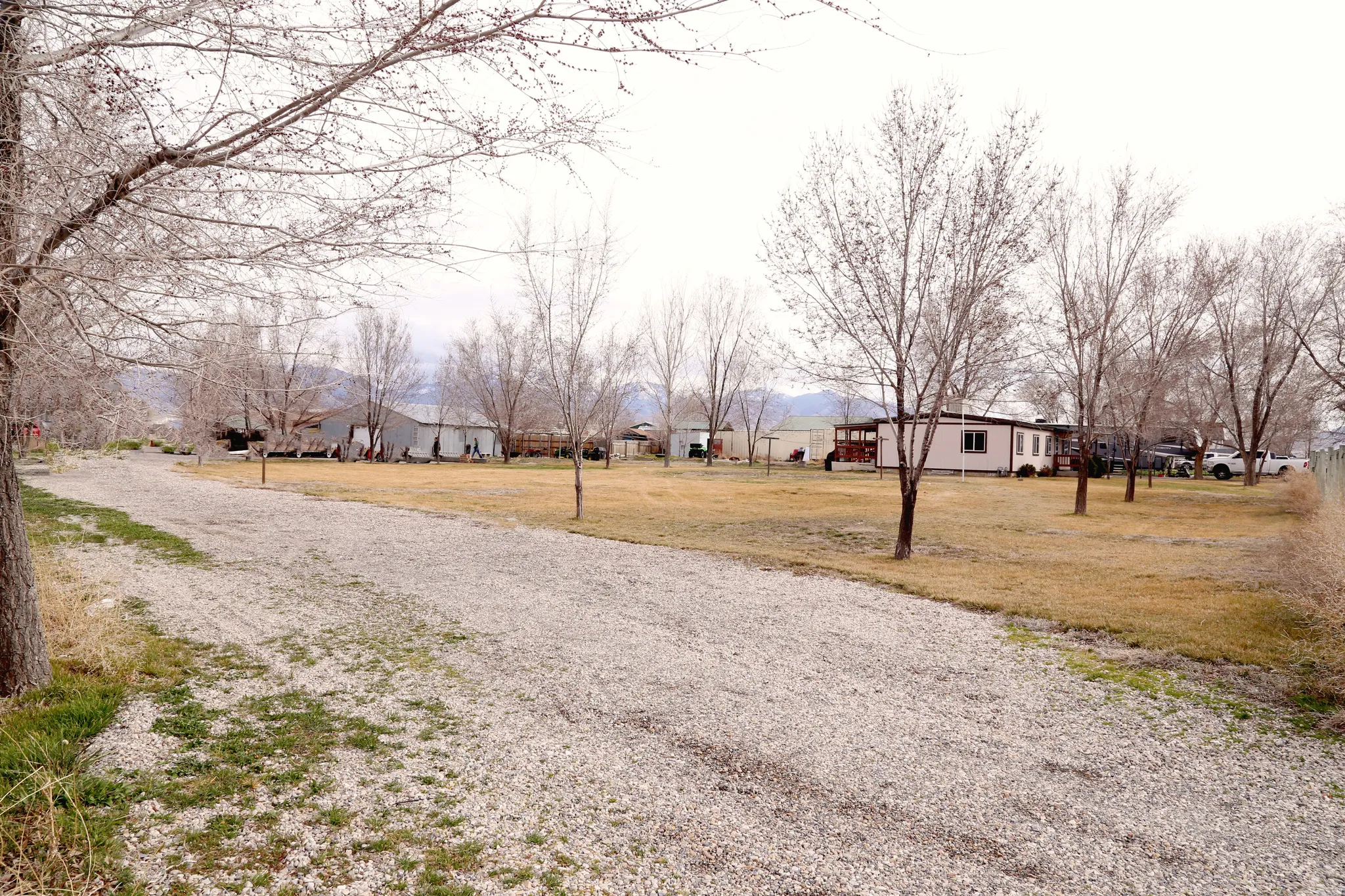 View of dirt / gravel road with a residential view