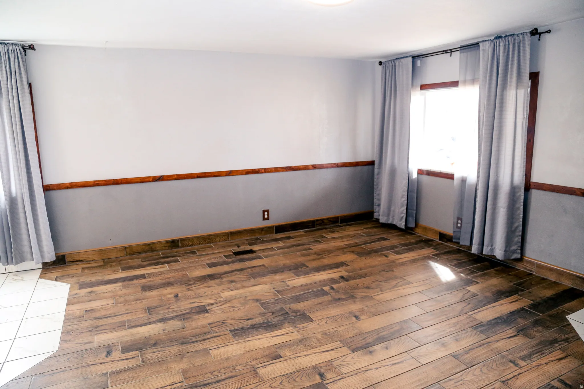 Spare room featuring dark wood-type flooring
