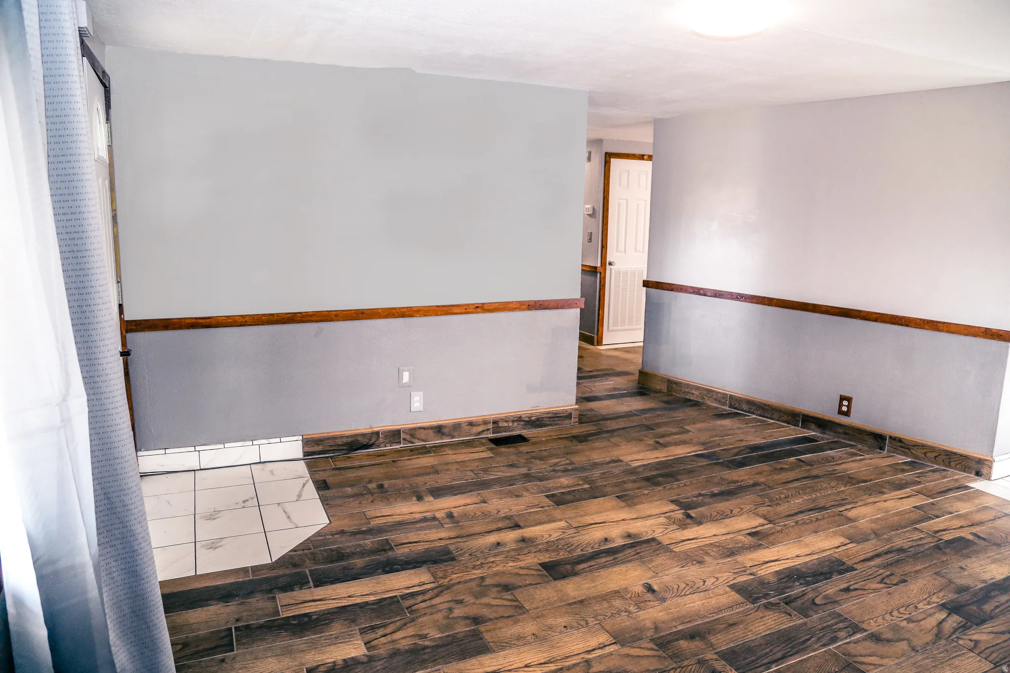 Empty room featuring dark wood-style flooring