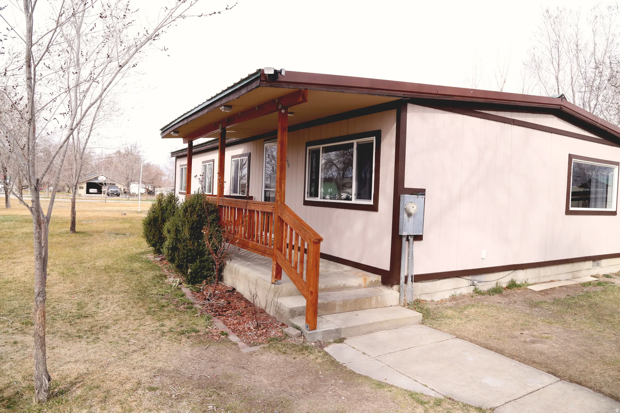 Property entrance with covered porch and a yard