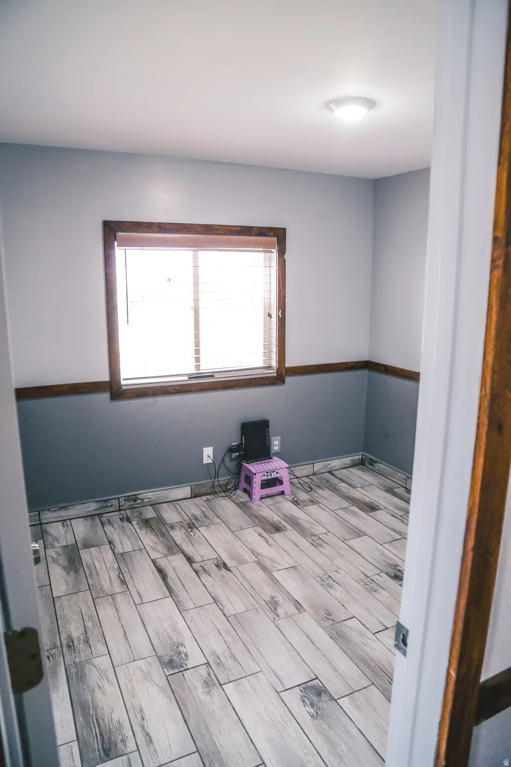 Spare room featuring wood tiled floors