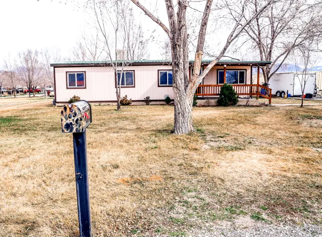 View of front of house featuring covered porch and a front yard