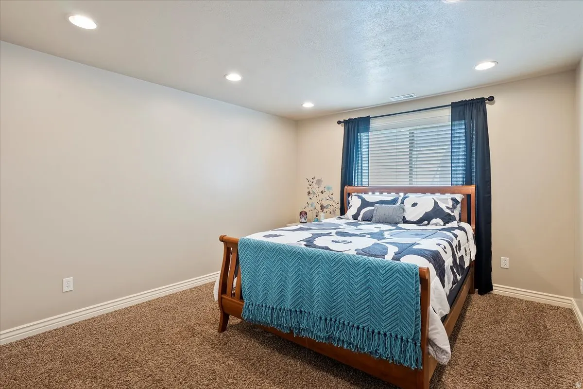 Bedroom featuring carpet and recessed lighting