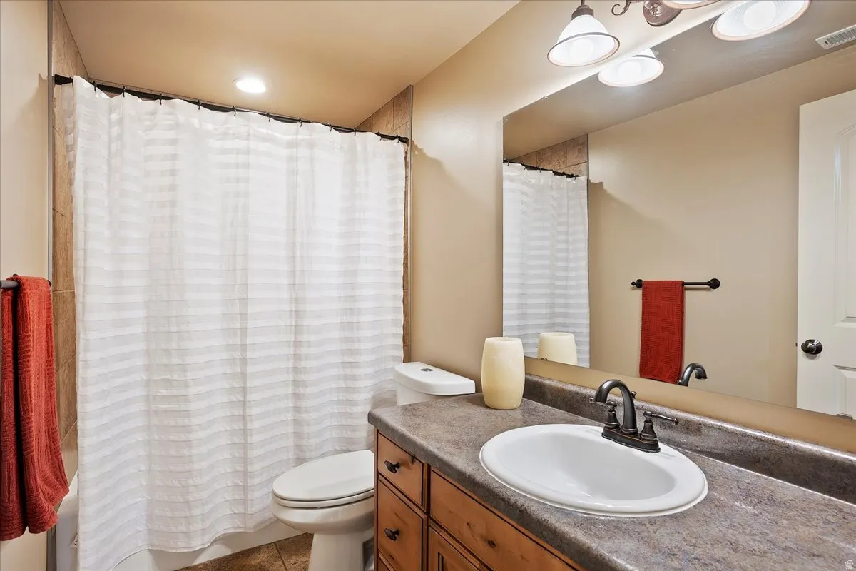 Full bathroom with vanity and shower / bath combination with curtain