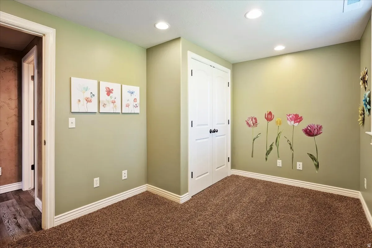 Hall with dark carpet and recessed lighting