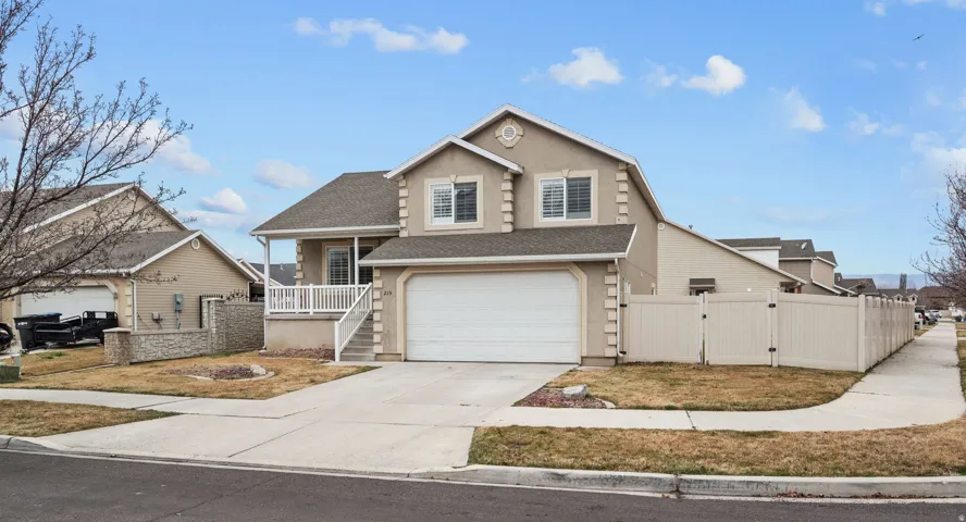 View of front of house featuring a gate, a shingled roof, driveway, a garage, and stucco siding