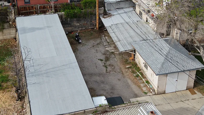 Storage shed and covered parking stalls