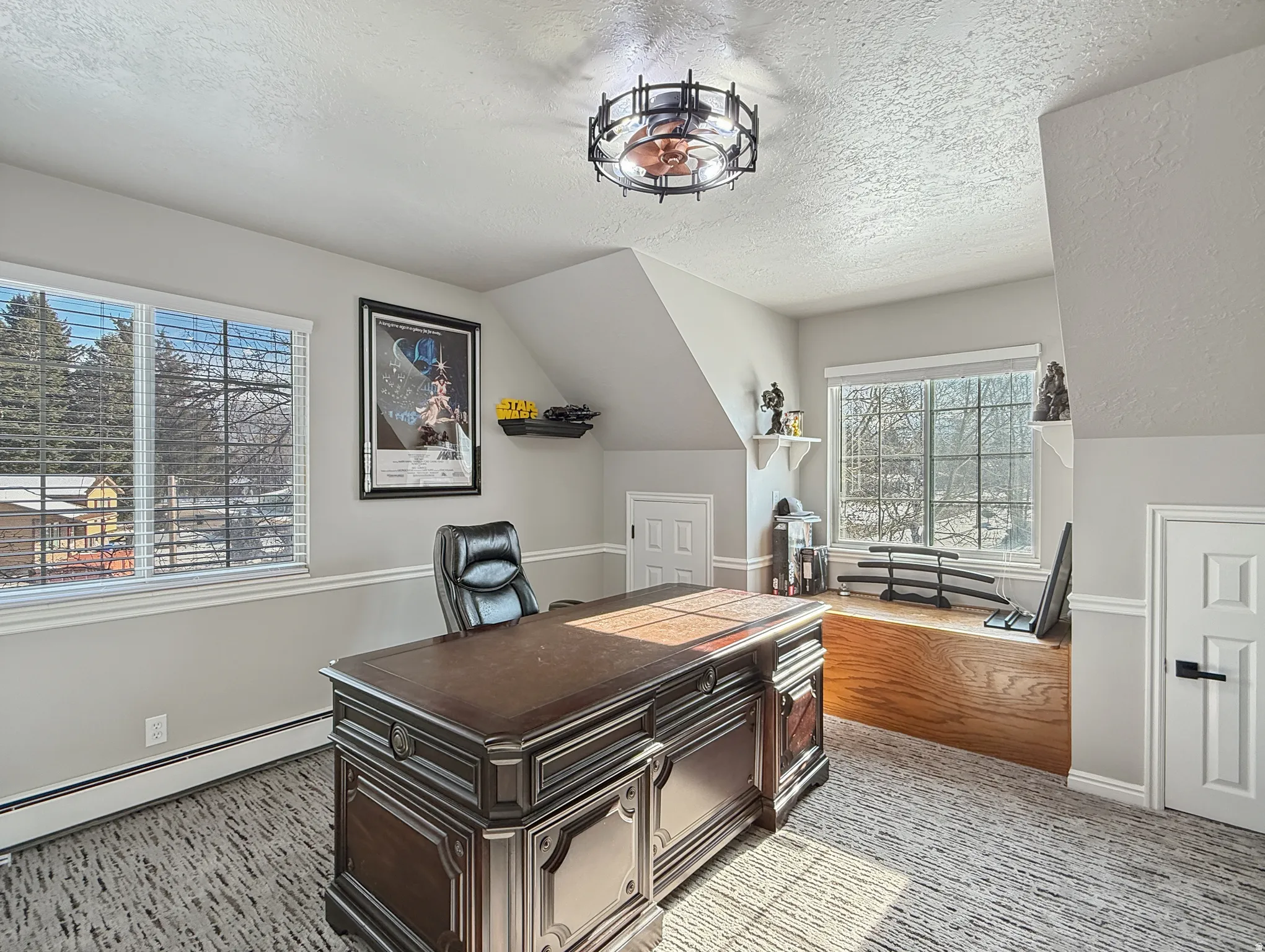 Office area with light carpet and baseboard heating