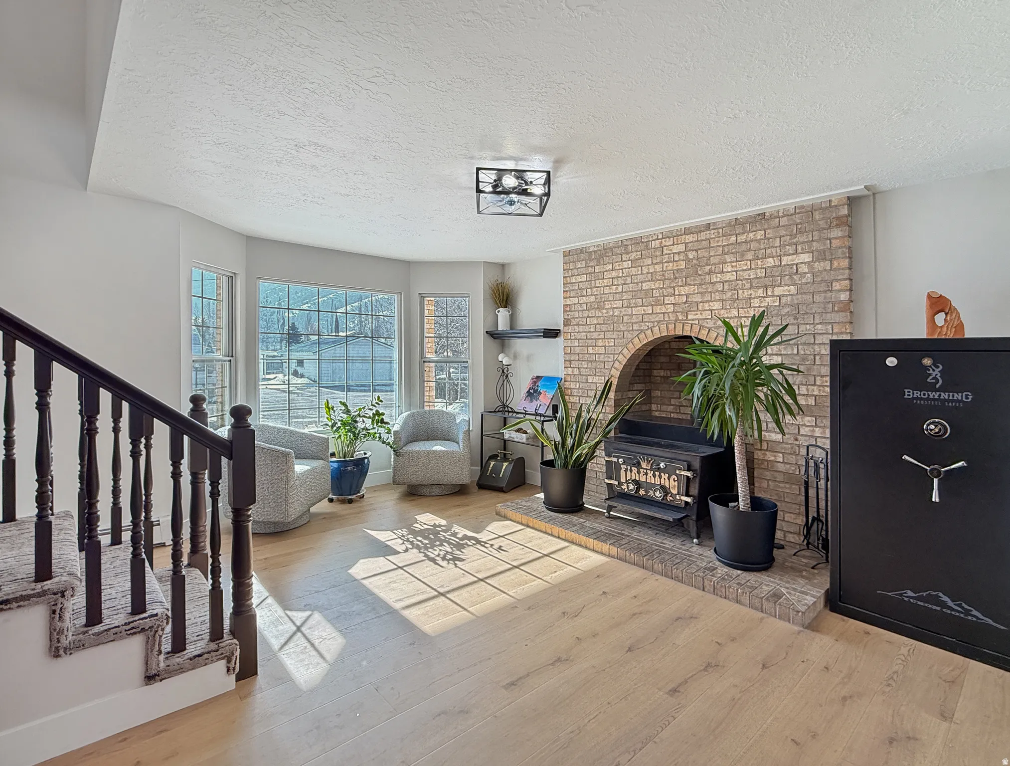 Living area with hardwood / wood-style flooring and a textured ceiling