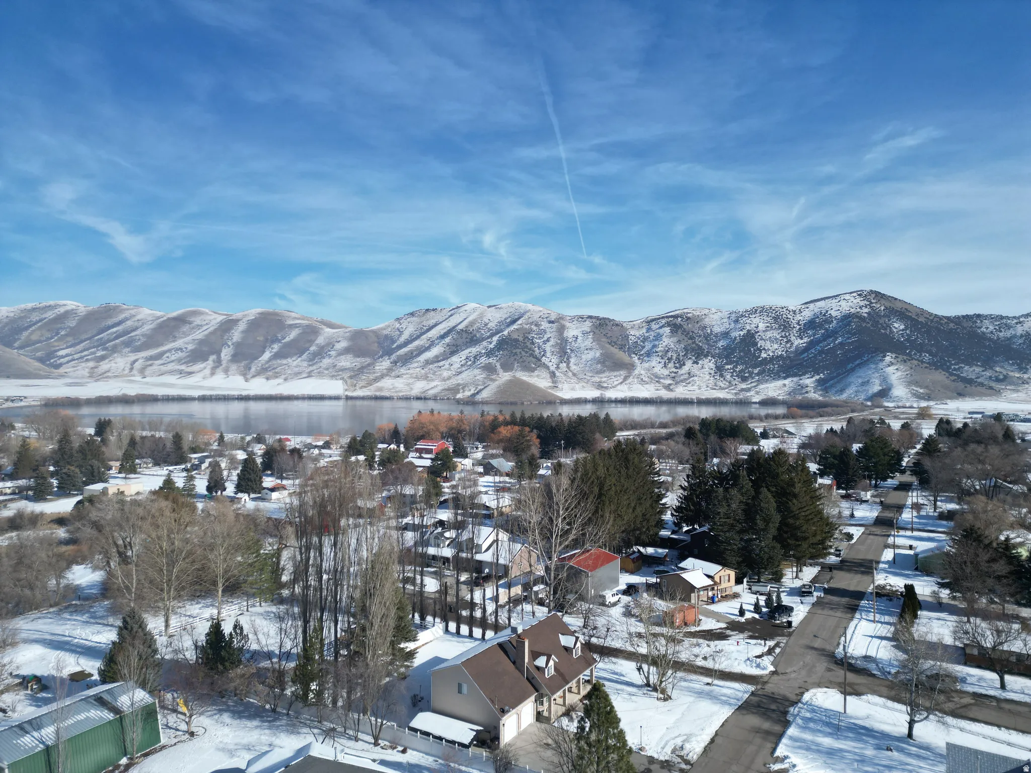 View of mountain background with nearby suburban area and a large body of water