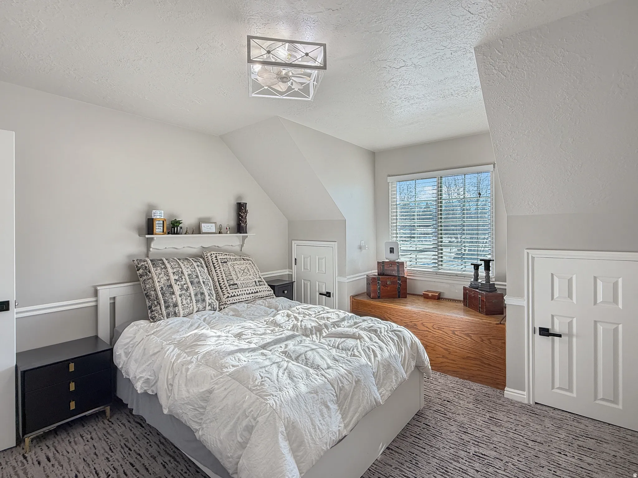 Carpeted bedroom with a textured ceiling