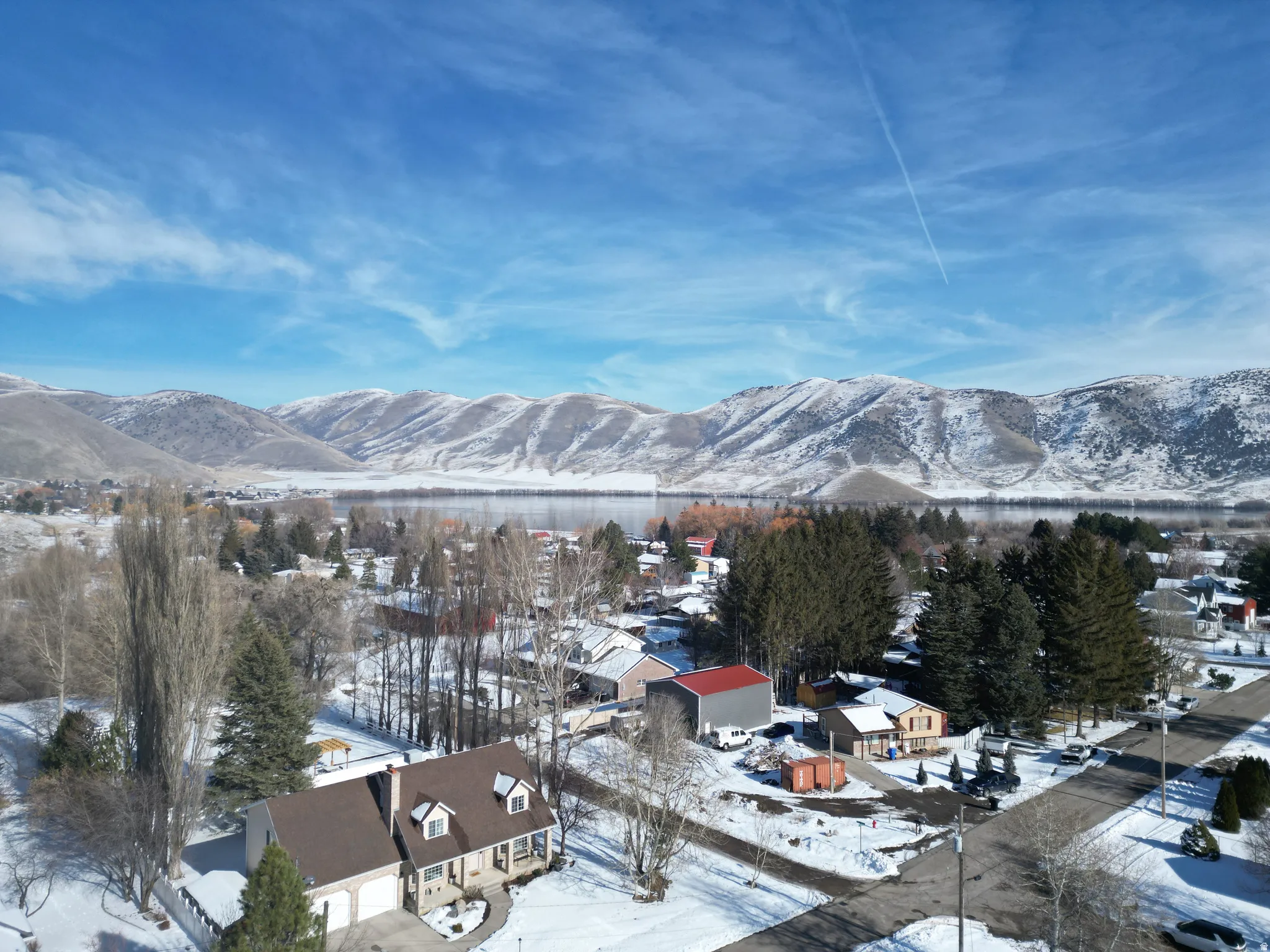 View of mountain background featuring a nearby body of water and nearby suburban area