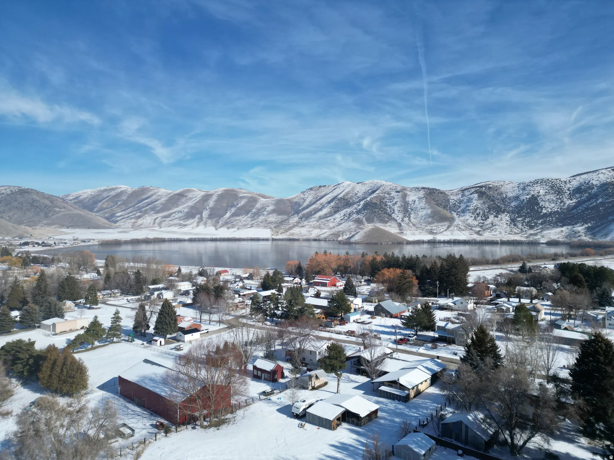 View of mountain background featuring nearby suburban area and a large body of water