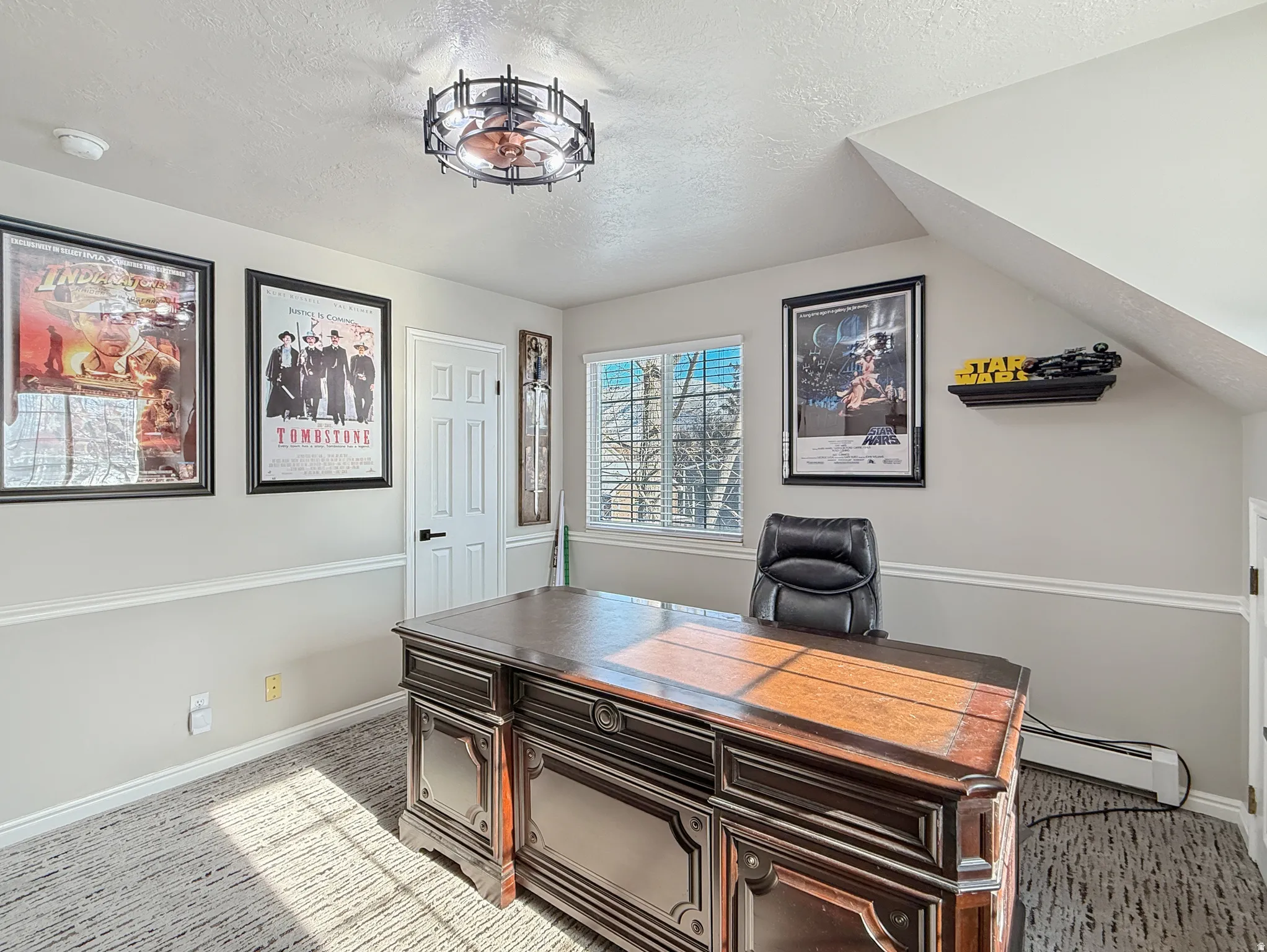 Office area with a baseboard radiator and light colored carpet