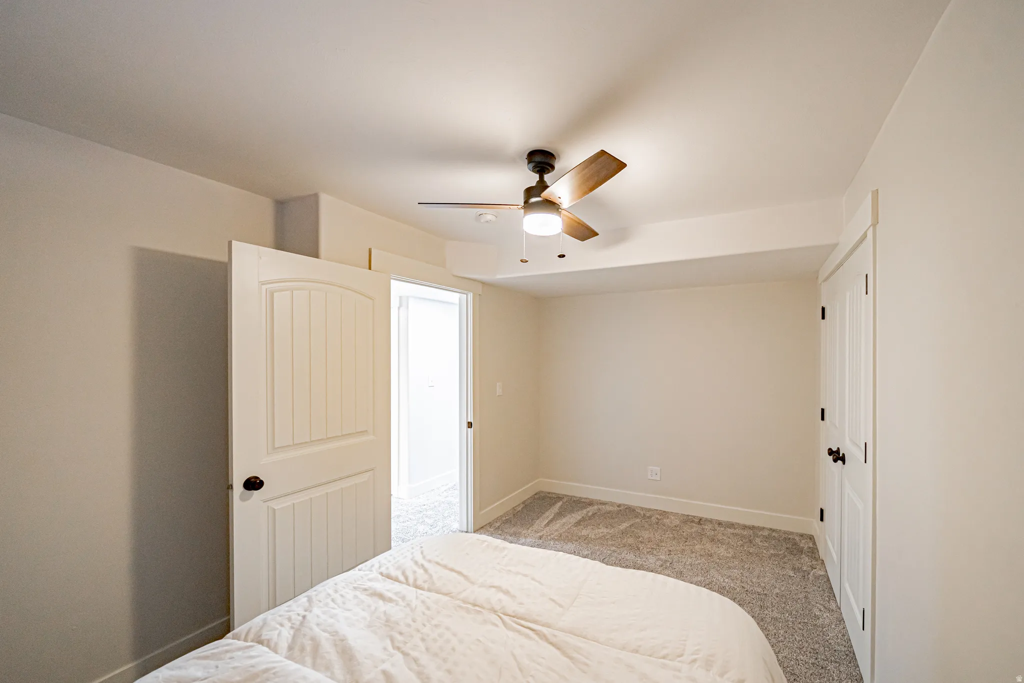 Bedroom featuring ceiling fan and light colored carpet