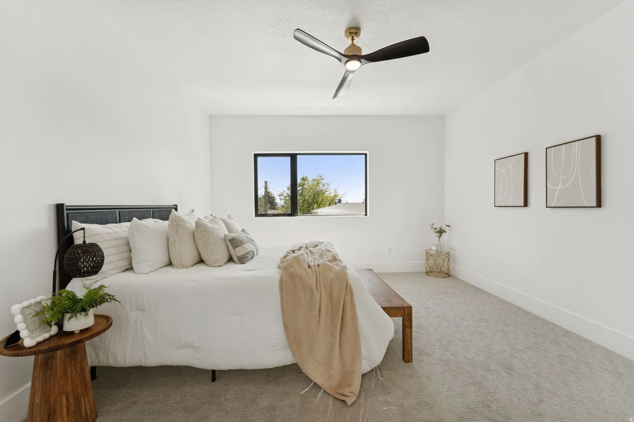 Carpeted bedroom featuring baseboards and ceiling fan