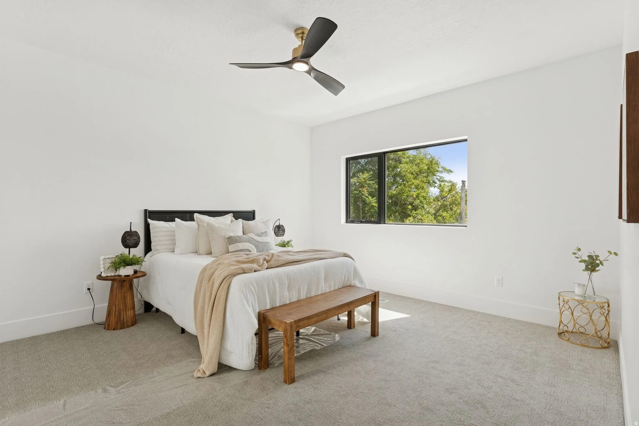 Bedroom featuring light carpet and ceiling fan