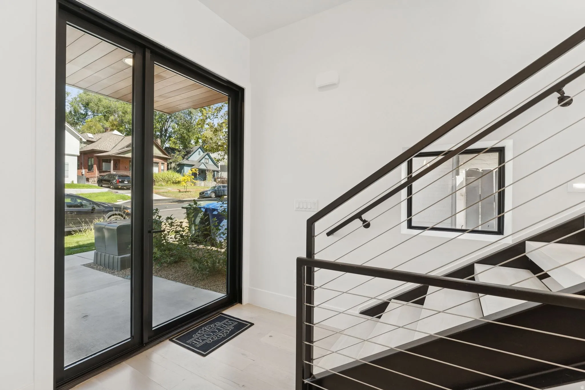 Entryway with stairs and wood finished floors