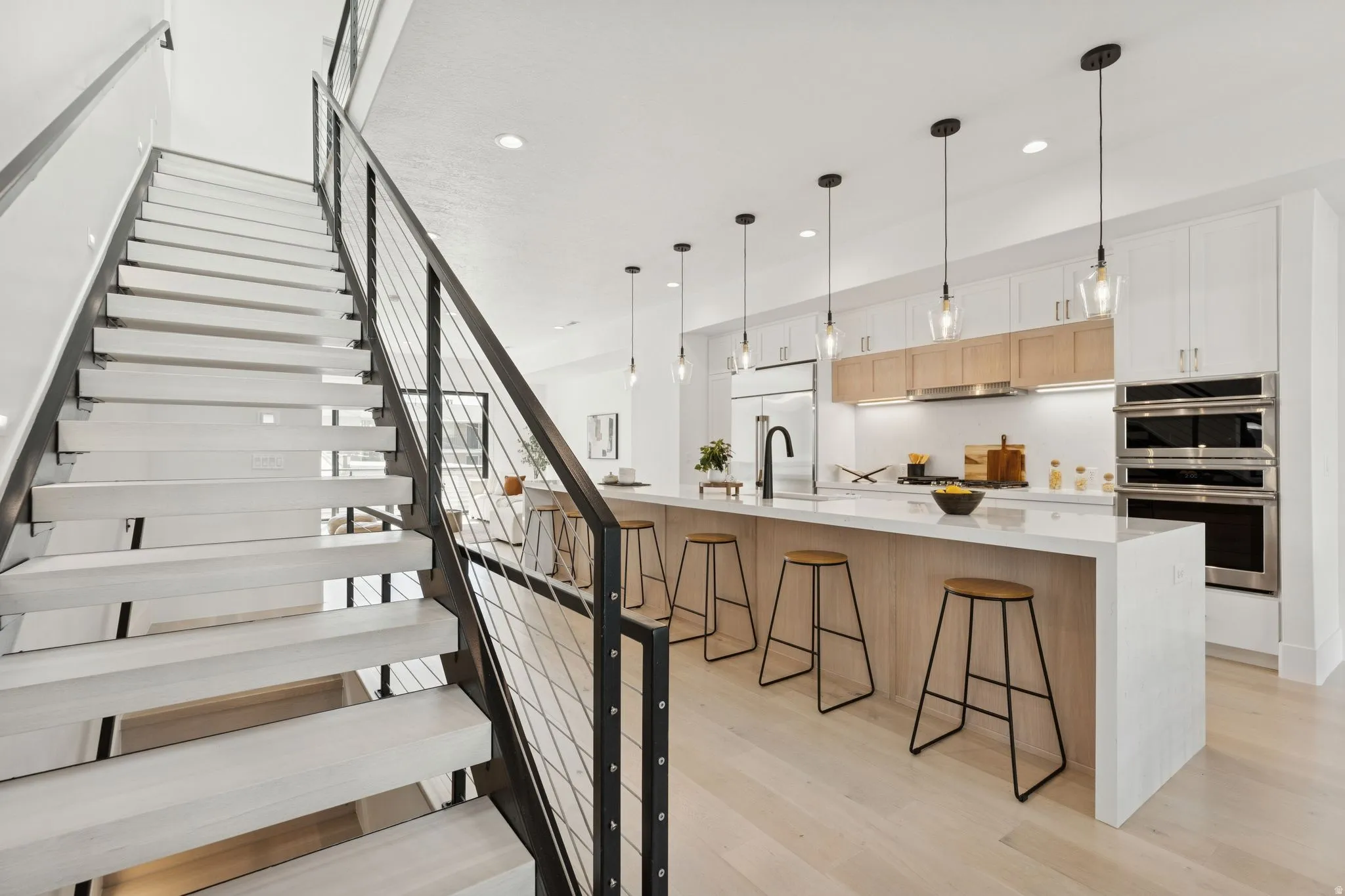 Staircase with wood finished floors and recessed lighting