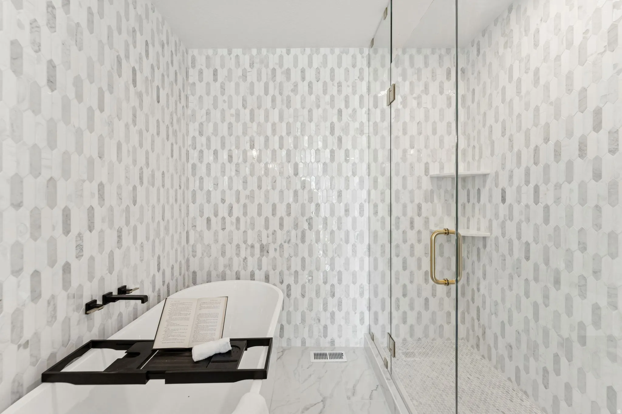 Full bath with a shower stall and a freestanding tub