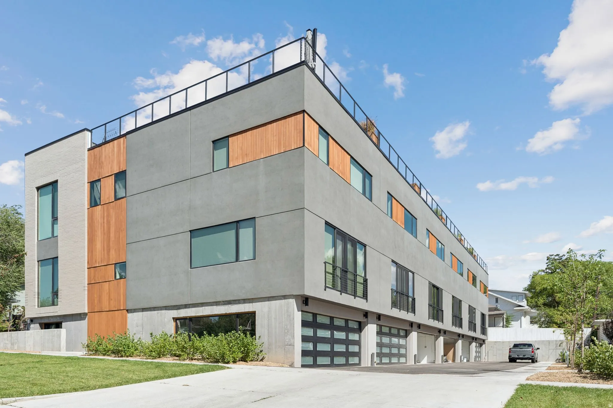 View of apartment building / complex with a garage and driveway