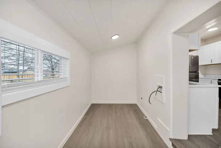 Unfurnished dining area featuring light wood-style floors, crown molding, lofted ceiling, and recessed lighting