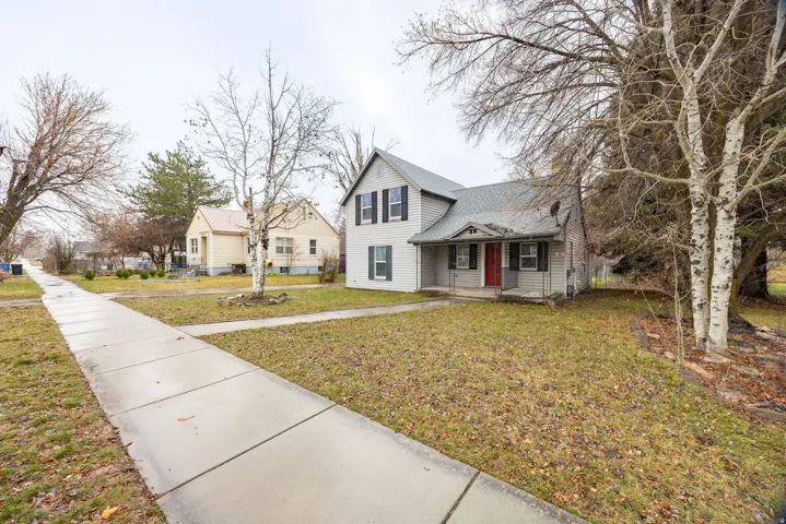 Traditional home with a front lawn and a porch