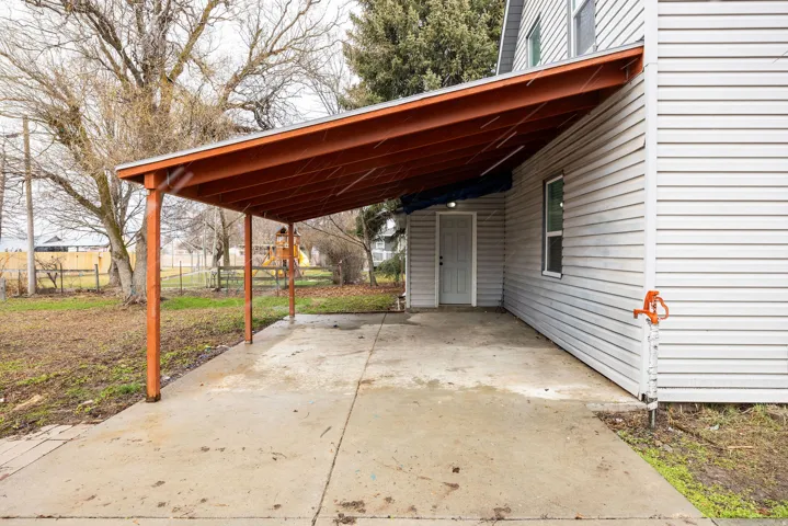 View of patio / terrace with a carport and concrete driveway