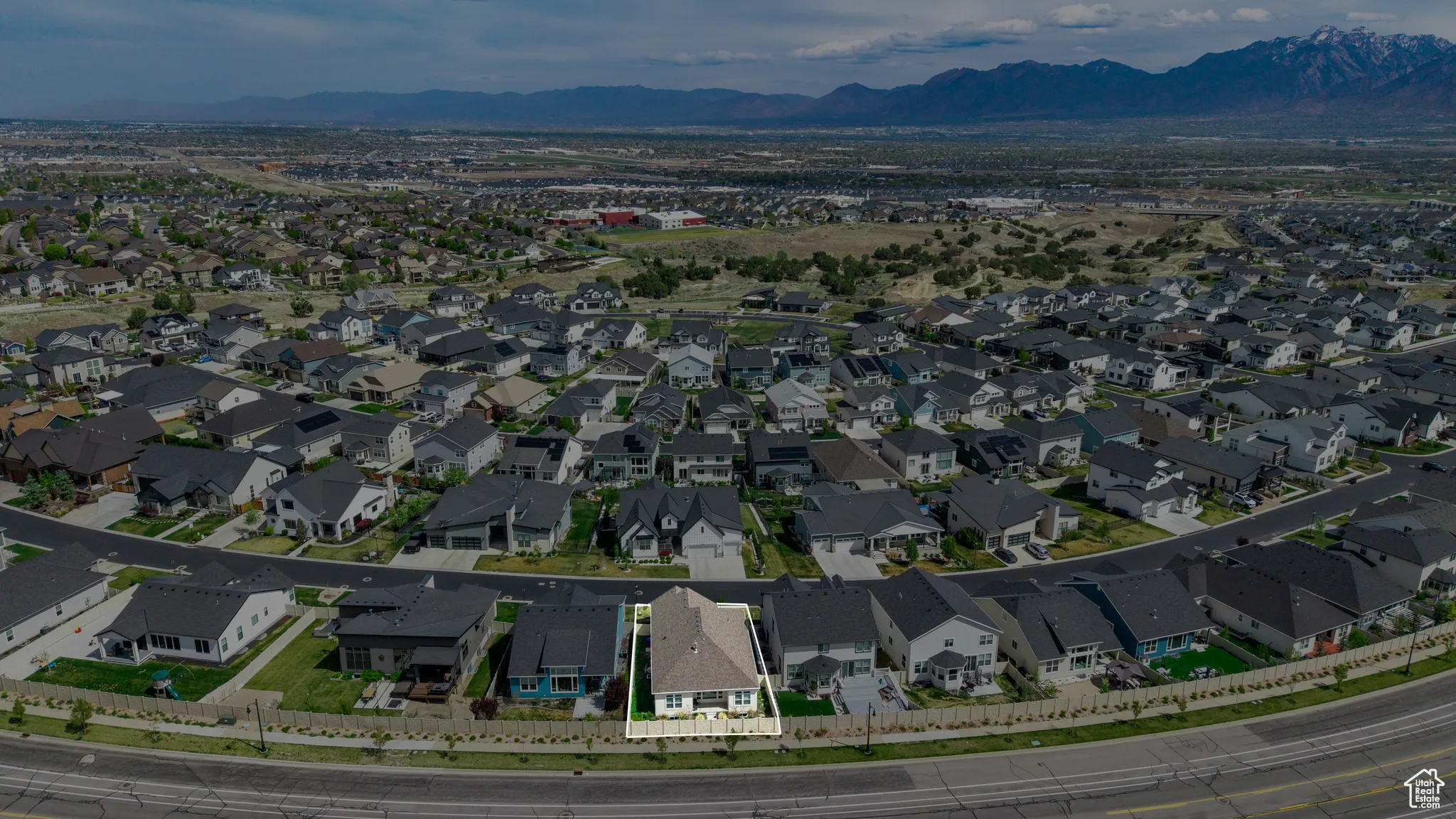 Aerial perspective of suburban area featuring a mountain backdrop