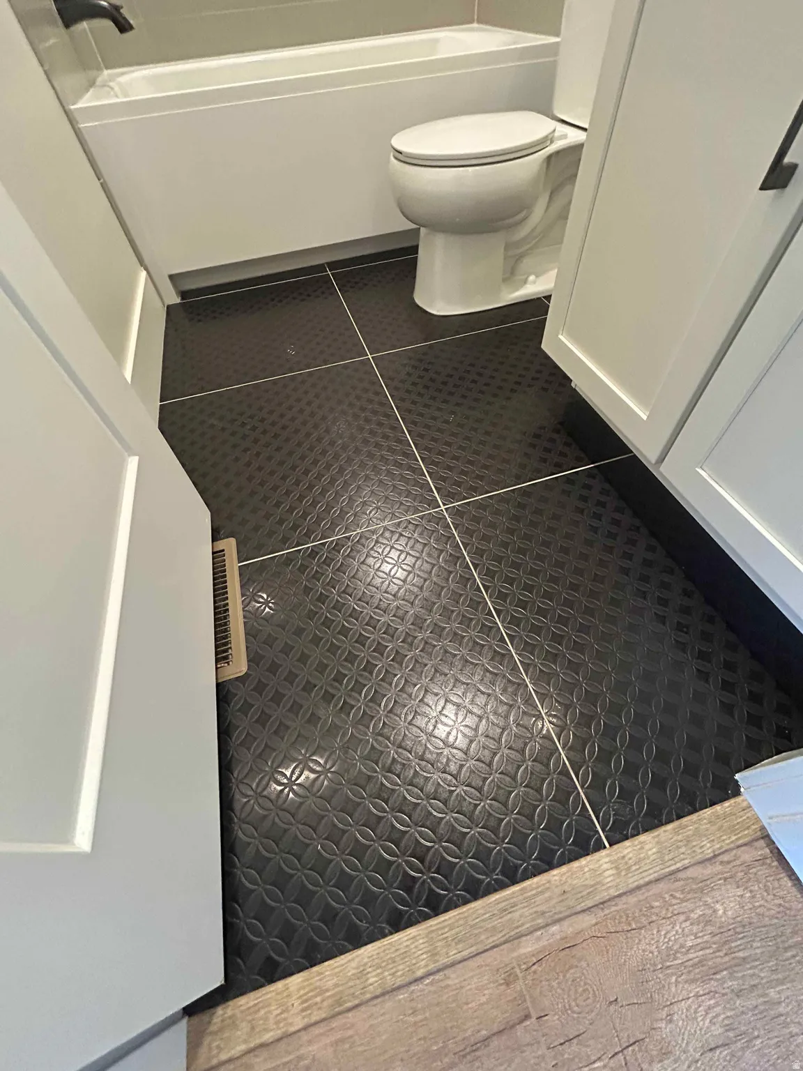Full bathroom with tile patterned floors and toilet