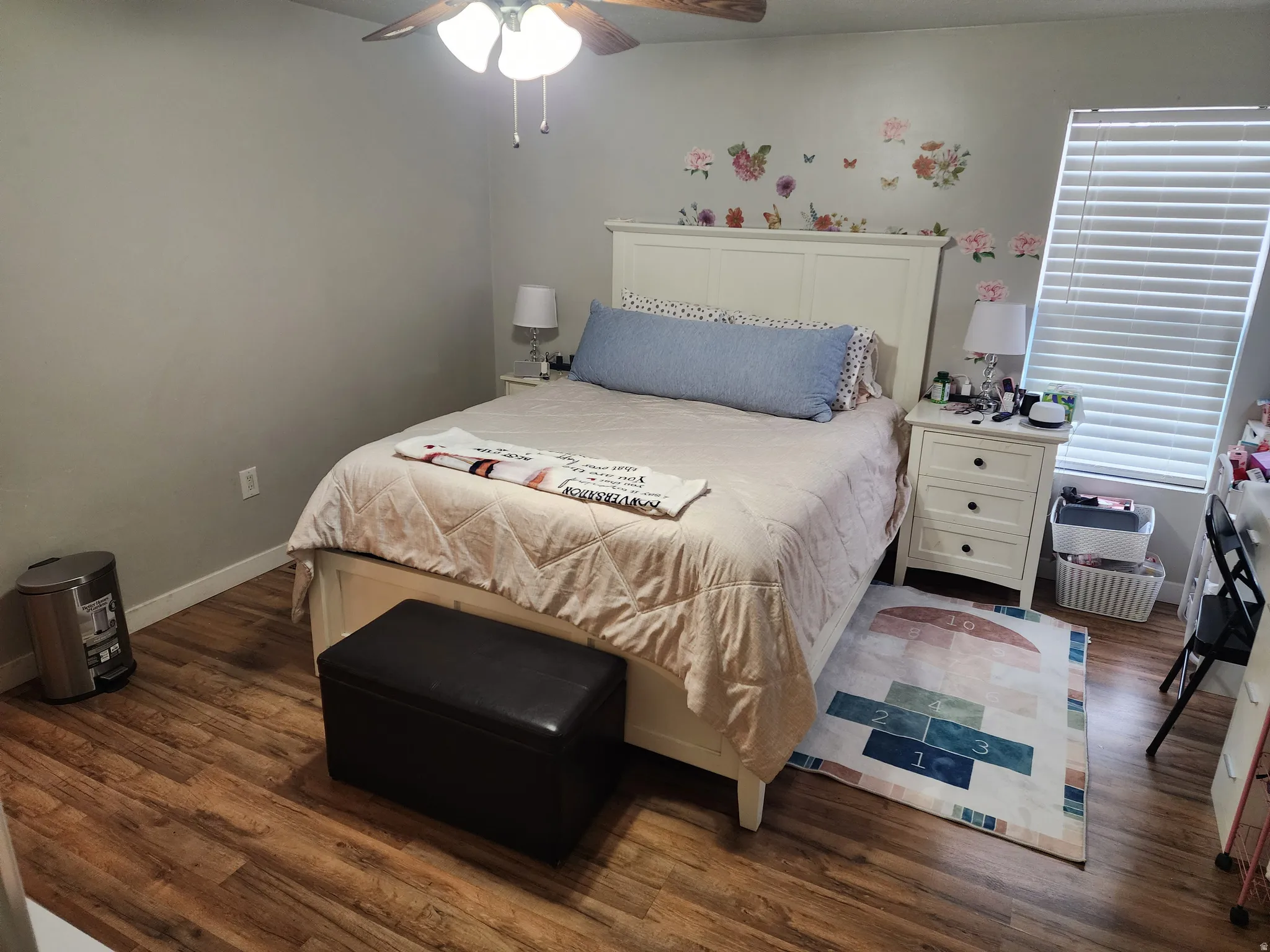 Bedroom with dark wood finished floors and ceiling fan